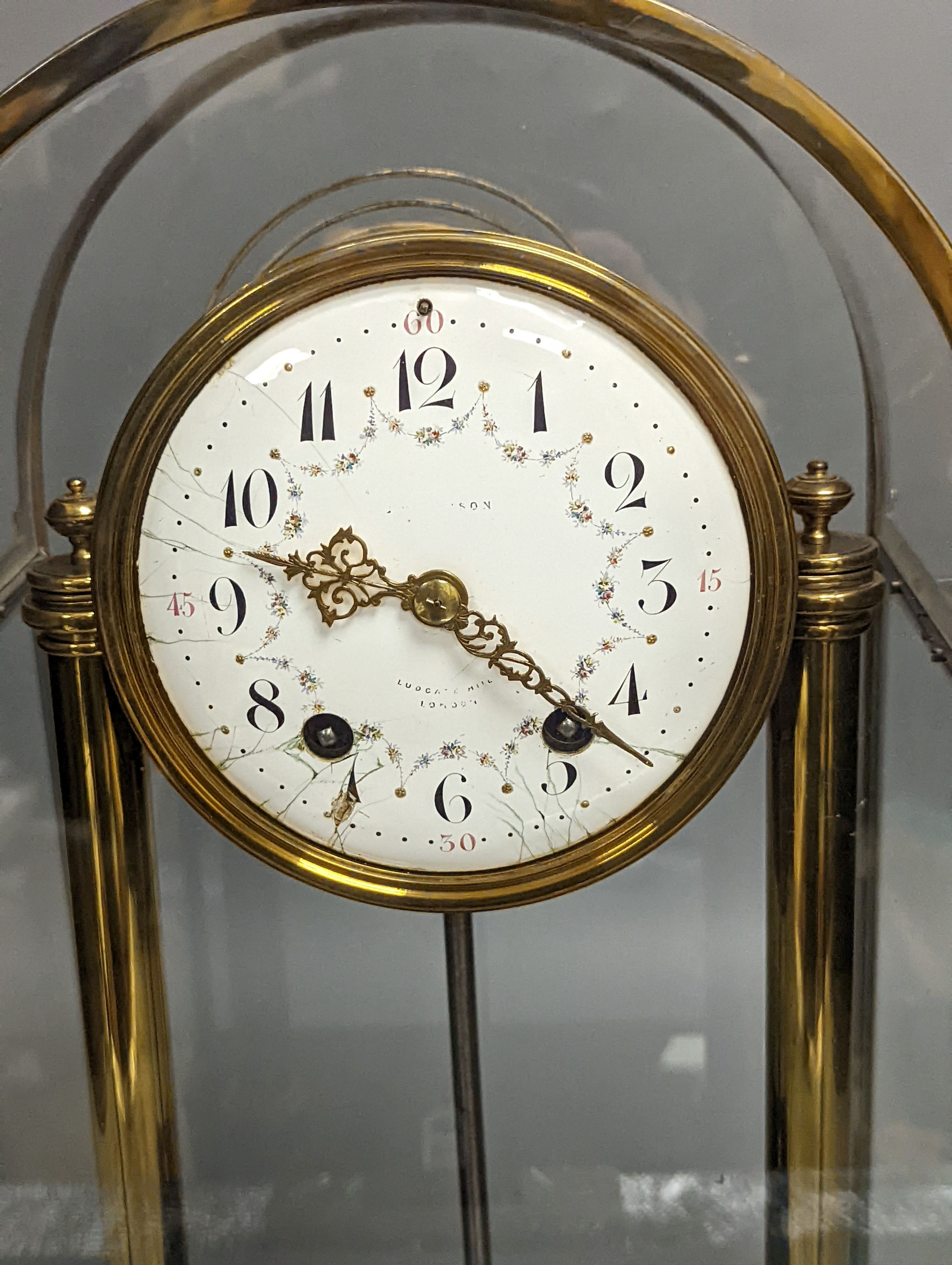 A large four glass clock, with decorative enamel dial, 43.5 cms high.
